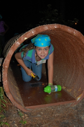 Girl Scout Crawling in Tunnel