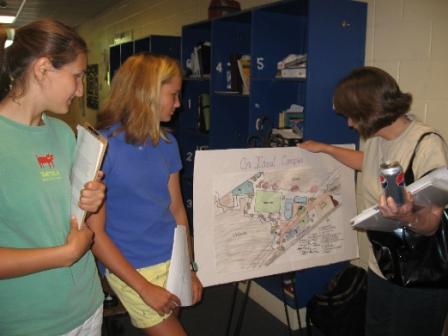 Students at LowCountry Prep in Pawleys Island, South Carolina present a drawing for their ideal campus to a faculty member