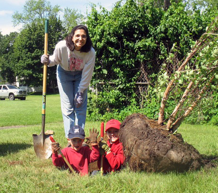students dig hole for tree