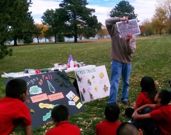 A science methods student from the education department at Metropolitan State University in Denver practices his teaching with Colfax Elementary School students, many of whom are English Language Learners, using a Project Learning Tree activity Signs of Fall in Sloan's Lake Park