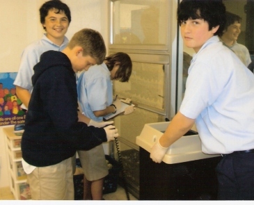 Students at St. Michael Lutheran school collect and weigh trash for recycling