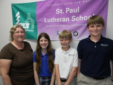 Teacher and students from St Paul Lutheran School in FL pose in front of their Certified PLT GreenSchools! banner