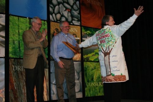 Reeda-Hart-accepts-award-wearing-signature-lab-coat