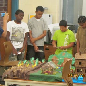 urban gardening students preparing for presentation of their farm model project