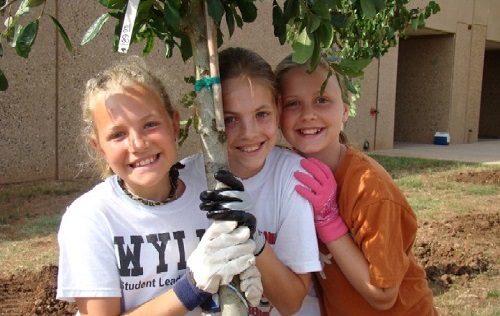 3-girls-hug-tree-they-planted-at-school