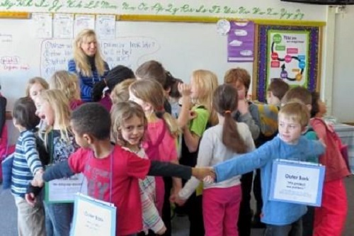 class-with-teacher-holding-hands-during-activity