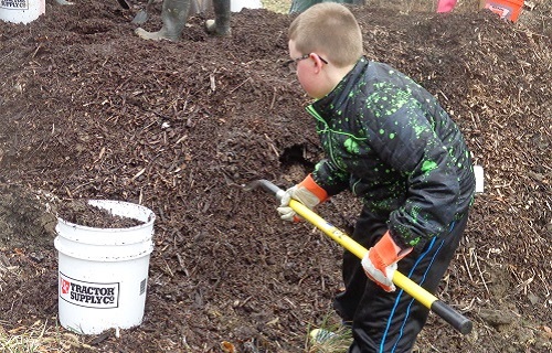 boy-shoveling-dirt-GreenWorks-project