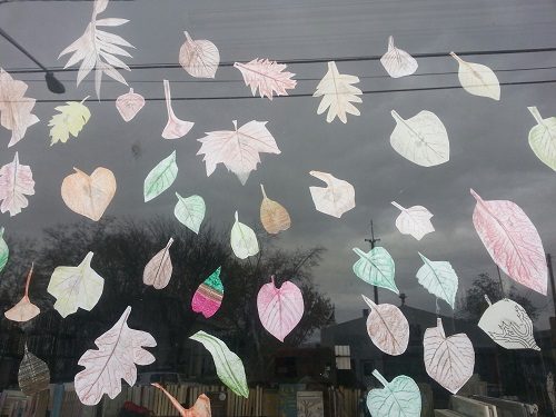 paper-cutouts-of-leaves-colored-and-taped-to-window