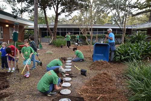 students-adults-working-to-create-outdoor-classroom