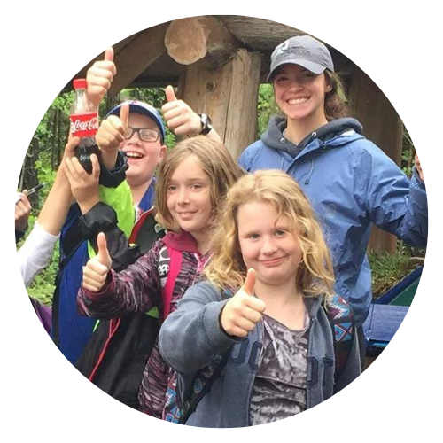 ellie and three students posing with thumbs up