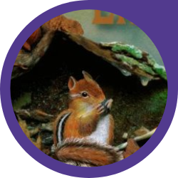 A chipmunk sitting in leaves beside a fallen log eating a seed