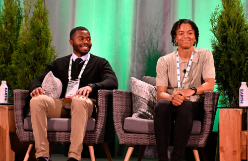 Alexis Martin and Aaron Evans sitting together on the stage at the 2023 SFI Annual Conference in Vancouver
