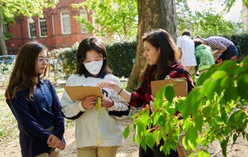 educator and two youth participating in PLT activity