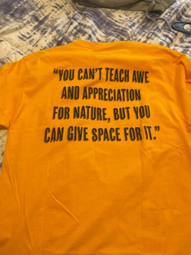 Image of t-shirt that says "You can't teach awe and appreciation for nature, but you can give space for it"